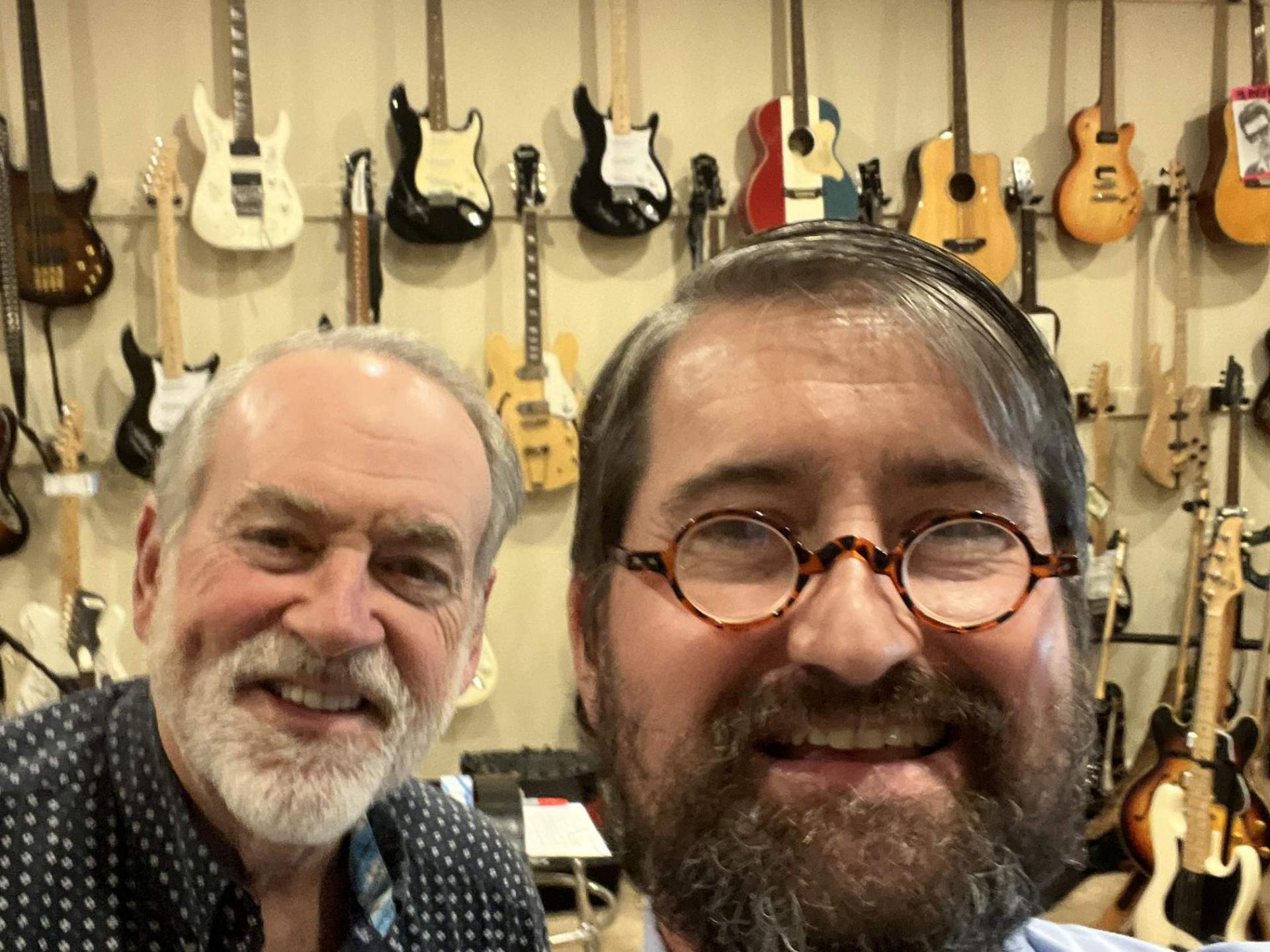 Cory Cox with Governor Mike Huckabee at his guitar collection